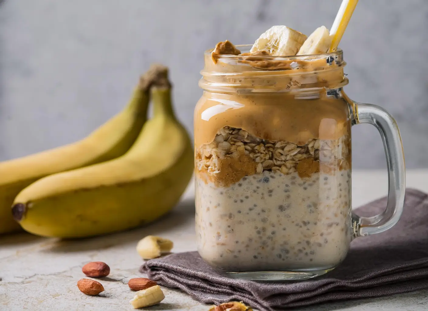 Delicious jar of banana oats topped with sliced bananas, a sprinkle of cinnamon, and a drizzle of honey